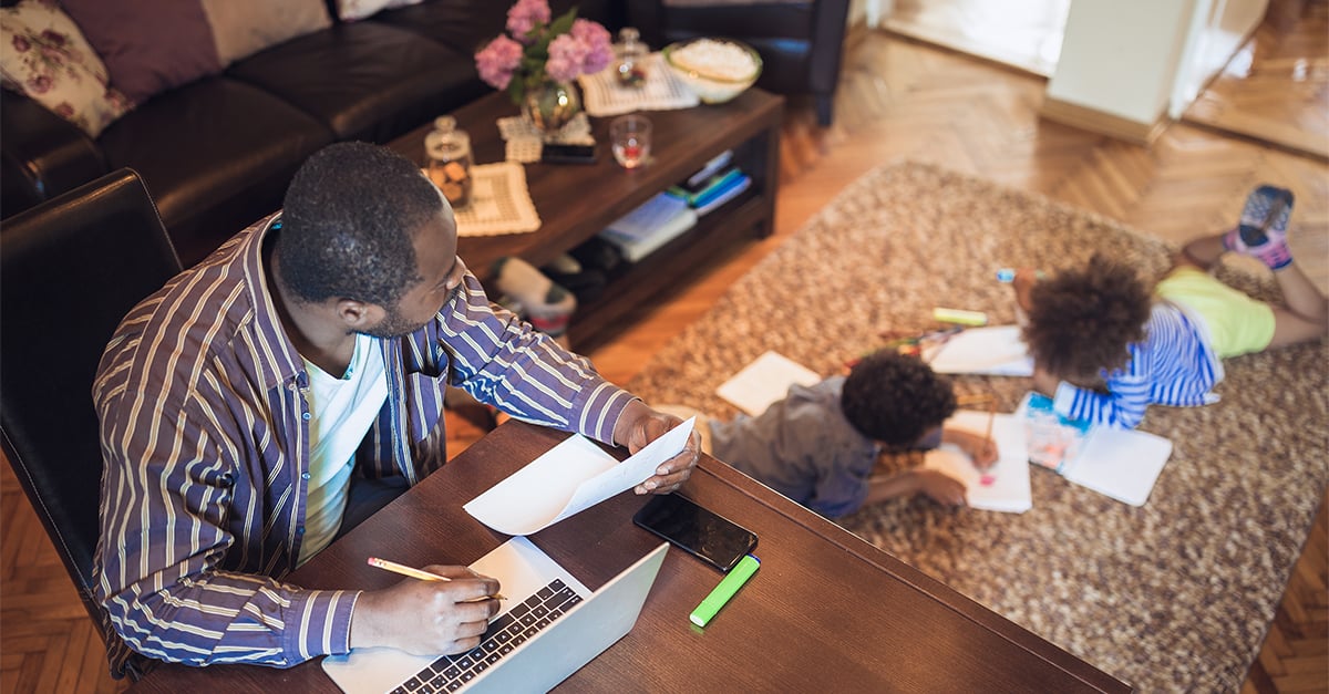 Man working at home with children in room